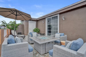 Rooftop terrace at Unit B with outdoor seating, fire table, and tropical views in Fort Lauderdale.