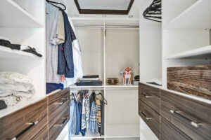 Custom walk-in closet with built-in shelving and drawers in Unit A, 624 NE 29th Drive