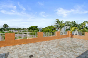 Expansive rooftop terrace with tile flooring and panoramic views from Unit A, Wilton Manors.