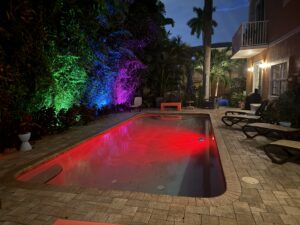 Pool at night with colorful LED lighting in Wilton Manors townhouse complex.