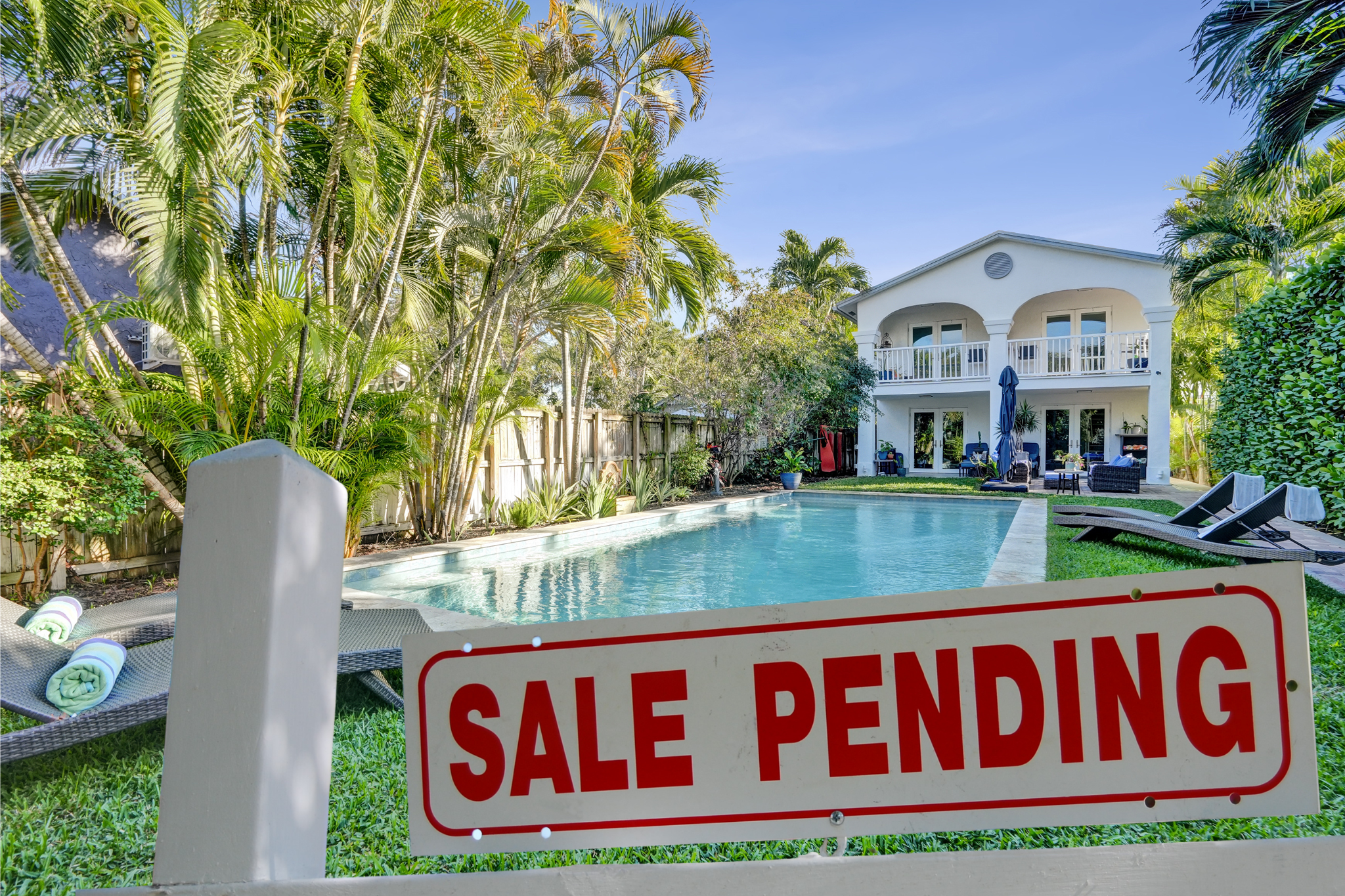Sale Pending sign in front of pool home at 1050 NE 33rd Street Oakland Park Florida listed by Scott Rivelli Charles Rutenberg Realty Fort Lauderdale