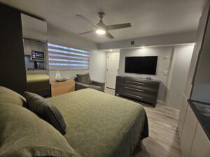 Furnished studio bedroom with queen bed and TV Lauderdale Tennis Club